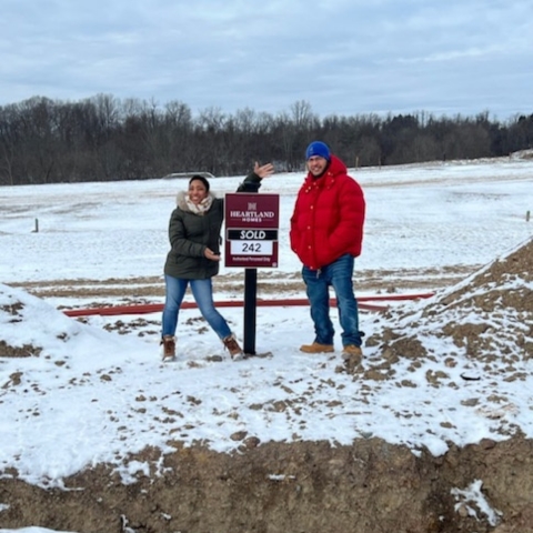 Couple celebrating new home purchase at Heartland Homes lot